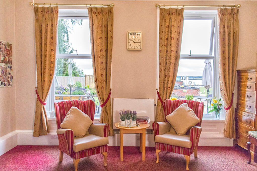 Chairs and table in front of windows